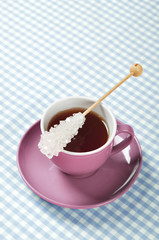 Tea in cup with candy sugar