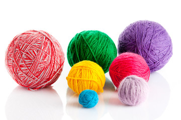 colorful different thread balls. wool knitting on white backgrou
