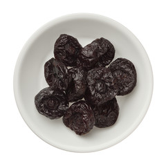 Isolated dried plums over white background, close up
