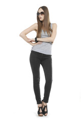 Fototapeta premium Full length The young long-haired girl posing in studio