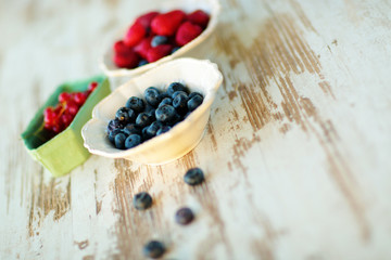Mix of blueberries, strawberries in vintage plates