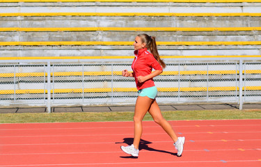 Sports woman running on tracks