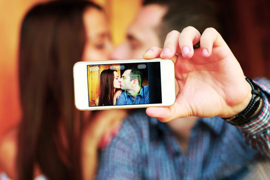 Couple taking self-portrait  photos with mobile smart phone