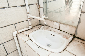 Closeup of old rusty dirty water drain in China