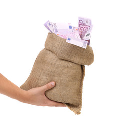 Hand holding bag with many banknotes