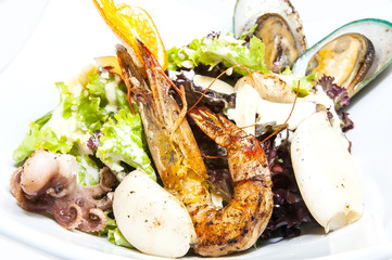 salad with vegetables and seafood on the table in a restaurant