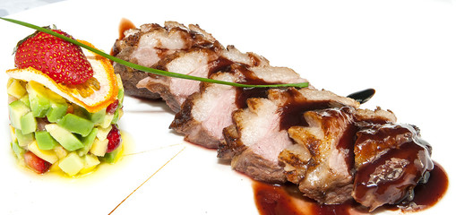 chicken breast with vegetables on a white plate