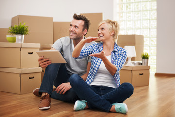 Happy couple planning decor in new home