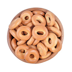 Bagels in a wooden bowl on a white background