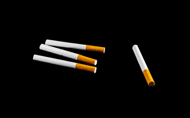 four cigarette isolated on black background