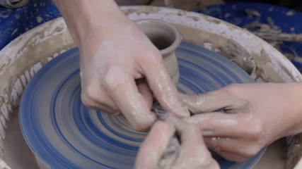 Potter teaches his craft to the children.