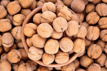Whole walnuts in a wooden bowl