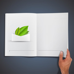 Green leaves inside envelope printed on book. 