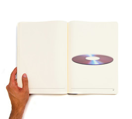 single CDs printed on white book.