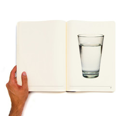 water glass full of water printed on white book.