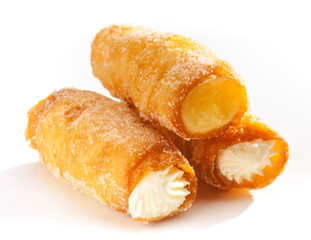 combs and honey pastry filled with cream, on white background