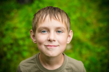 Close-up portrait of smiling little boy outdoors