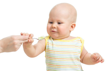 Little baby feeding with a spoon