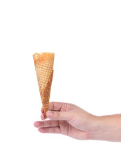Hand holds empty sugar waffle cone