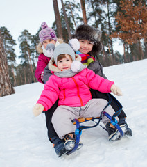 Children on sleds in snow