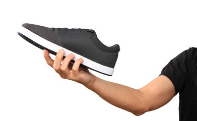 Hand with a new sport shoe