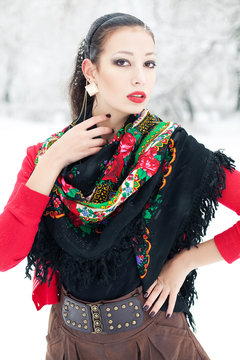 Winter girl in red cardigan with russian kerchief