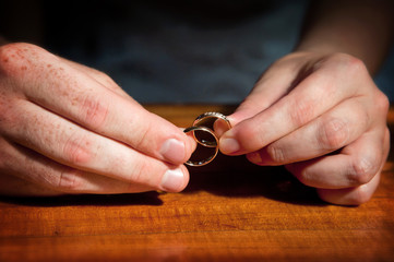 pair of hands with wedding rings