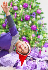 Happy boy near Christmas tree