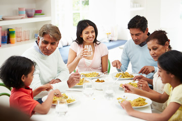 Indian Family Eating Meal At Home