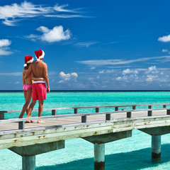 Couple on a beach jetty at Maldives
