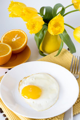 Scrambled eggs and oranges for breakfast