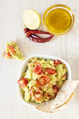Fresh guacamole with tomatoes