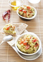 Fresh guacamole with tomatoes