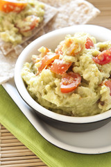 Fresh guacamole with tomatoes