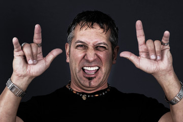Man making devil gesture