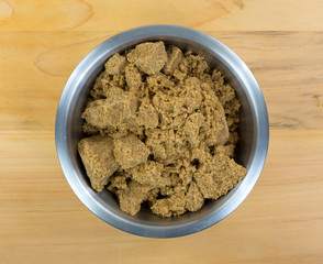 Dark brown sugar in stainless steel bowl