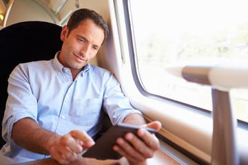 Man Reading E Book On Train