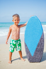 Naklejka na ściany i meble boy has fun with the surfboard