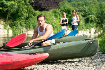 Man sitting by kayak