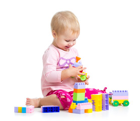 child girl playing with construction set over white background