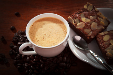 hot coffee on brownie cake on wood table