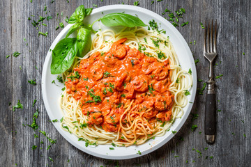 Spaghetti bolognese with seafood and basil