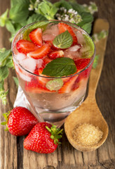 mojito strawberry cocktails, strawberry, mint leaves on a wooden