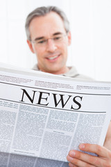 Naklejka premium Mature Man Reading Newspaper
