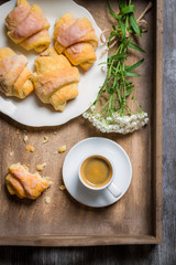 Breakfast in bed with a croissant and flowers