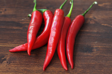 chili peppers on wood background