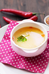 soup with chili peppers on wood table