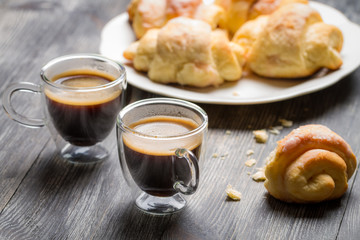 Two cups of espresso and croissants for breakfast
