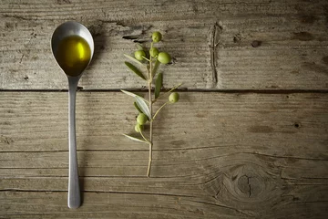 Fotobehang olive branch and a spoon full of oil © vkara