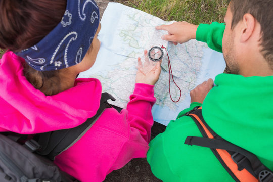 Couple using compass and map